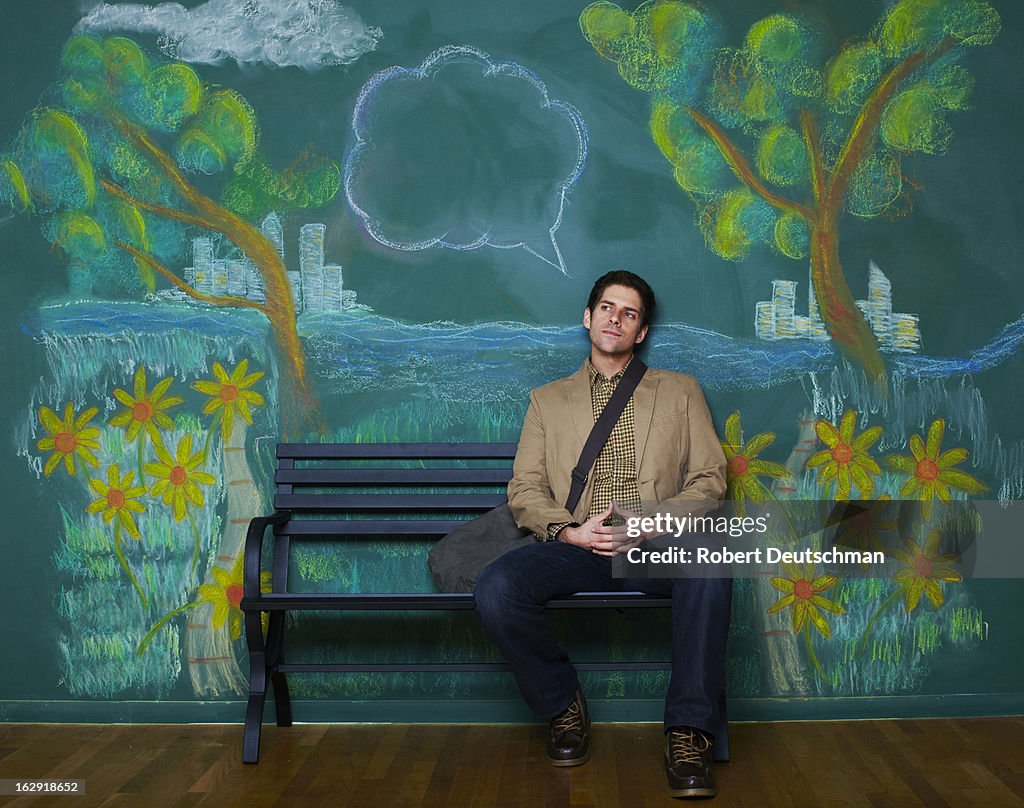 A man sitting on a park bench thinking.