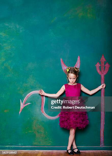 a young girl with a pitchfork and horns. - máscara de diabo imagens e fotografias de stock