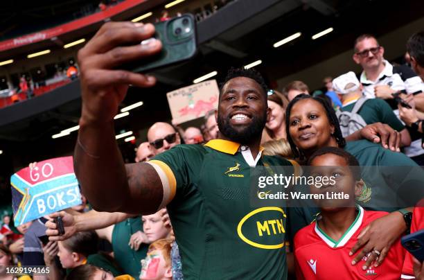 South African Captain, Siya Kolisi takes pictures with fans after the Summer International match between Wales and South Africa at Principality...