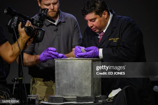 Military Academy members open and unveil the contents of a nearly 200-year-old time capsule during a ceremony in the Robinson Auditorium at Thayer...