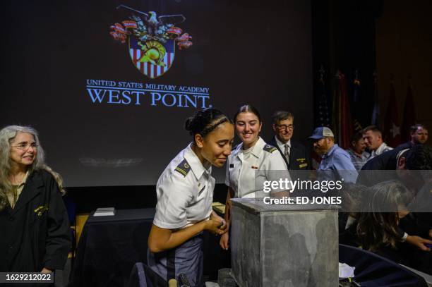 People look into a nearly 200-year-old time capsule during a ceremony in the Robinson Auditorium at Thayer Hall of the US Military Academy in West...