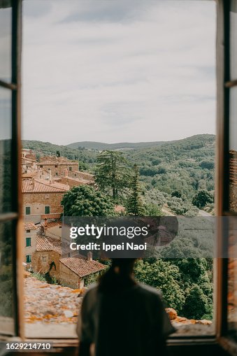 Girl looking at view of medieval village in Tuscany Girl looking at view of medieval village in Tuscany