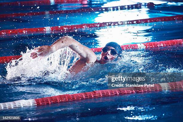 a man taking breath during swimming freestyle - boy swimming pool stock pictures, royalty-free photos & images