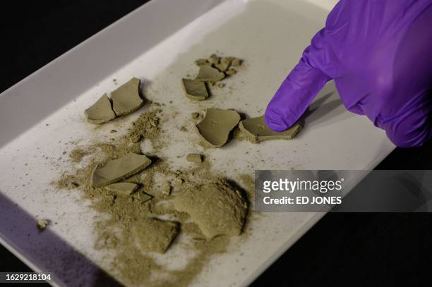 Contents are displayed from a time capsule thought to be nearly 200-years-old during a ceremony in the Robinson Auditorium at Thayer Hall of the US...