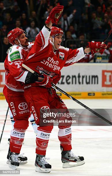 Charles Stephens of Koeln celebrates with team mate John Tripp after scoring his teams second goal during the DEL match between Koelner Haie and ERC...