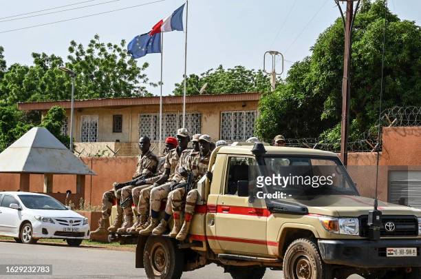 Patrol of the Niger national Police drives past the French Embassy in Niamey on August 28, 2023. Thousands of people demonstrated on August 27, 2023...
