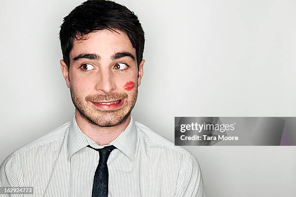 business man embarrassed with lipstick on face - cheek stock pictures, royalty-free photos & images