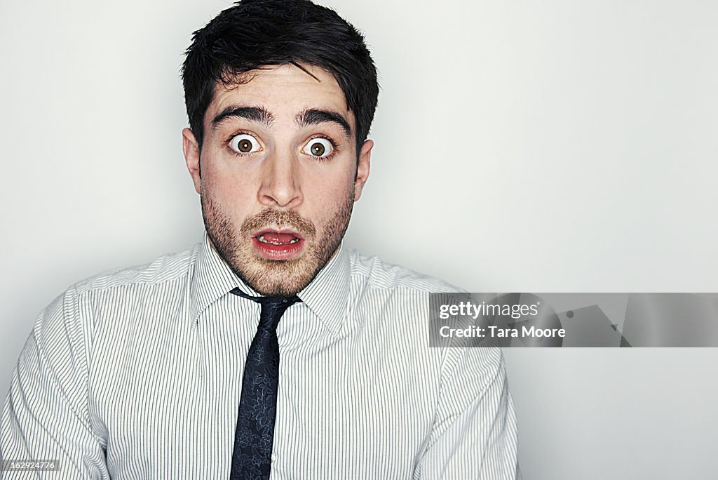 Business man looking very frightened and shocked