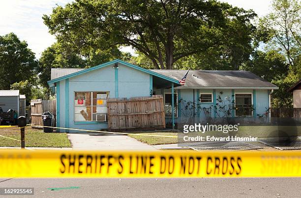Police tape surrounds the house of Jeff Bush, who was consumed by a sinkhole while lying in his bed last night, March 1, 2013 in Seffner, Florida....