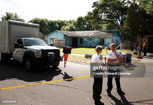 Police tape surrounds the house of Jeff Bush, who was consumed by a sinkhole while lying in his bed last night, March 1, 2013 in Seffner, Florida....