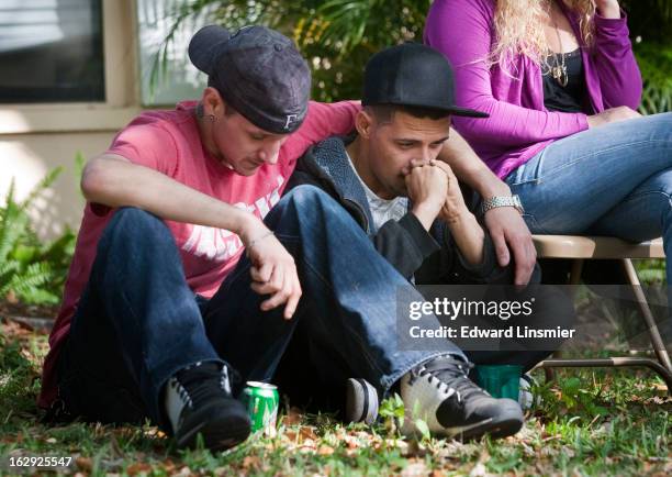 Jeff Bush's cousin Kyle Balcom and brother Dustin Bush react after he was consumed by a sinkhole while lying in his bed last night, March 1, 2013 in...