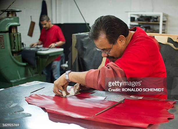 Worker cuts leather in the factory where the shoes given to Pope Benedicto XVI during his 2012 visit to Mexcio were made, in Leon, Guanajuato State,...