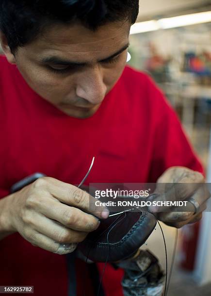 Worker sews a shoe in the factory where the shoes given to Pope Benedicto XVI during his 2012 visit to Mexcio were made, in Leon, Guanajuato State,...