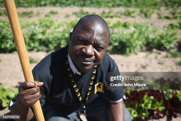 Timothy Olorunfemi, a farm program coordinator for the New Roots community garden program held by the International Rescue Committee , pauses from...
