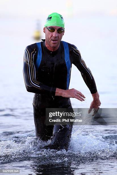 Bervan Docherty of New Zealand exits the water after the swim leg during the New Zealand Ironman on March 2, 2013 in Taupo, New Zealand.