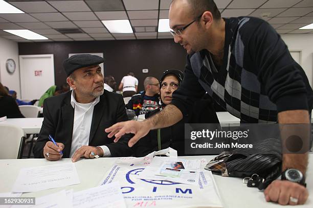 Recently-arrived Iraqi refugees learn about how to receive food stamps during a class held by the Arizona Department of Economic Security at the...