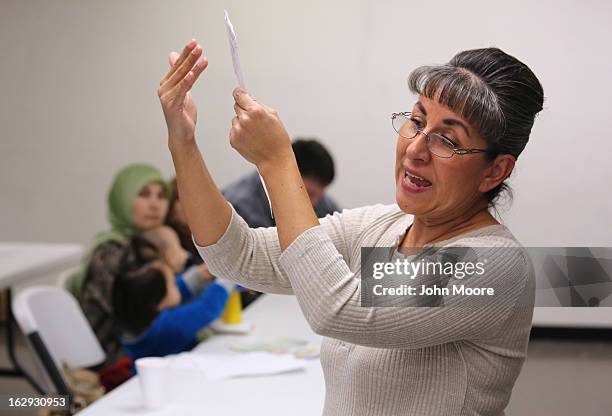 Recently-arrived refugees learn how to receive food stamps during a class held by the Arizona Department of Economic Security at the International...