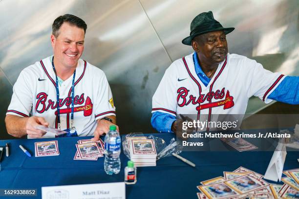 Former Atlanta Braves Matt Diaz and Gary Matthews sign autographs during Braves alumni weekend before the game against the San Francisco Giants at...
