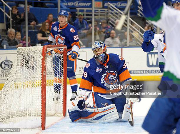 Rick DiPietro of the Bridgeport Sound Tigers reacts after allowing one of five goals during the first period of an American Hockey League game...