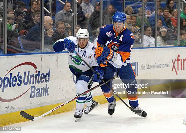 Ty Wishart of the Bridgeport Sound Tigers looses his stick as he skates against Kris Newbury of the Connecticut Whale during an American Hockey...