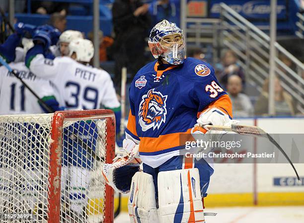 Rick DiPietro of the Bridgeport Sound Tigers reacts after allowing one of five goals during the first period of an American Hockey League game...