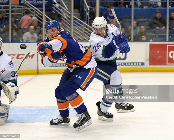 John Persson of the Bridgeport Sound Tigers reaches for the puck against Sean Collins of the Connecticut Whale during an American Hockey League game...