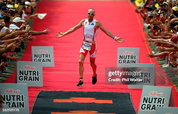 Bevan Docherty of New Zealand celebrates winning the New Zealand Ironman on March 2, 2013 in Taupo, New Zealand.