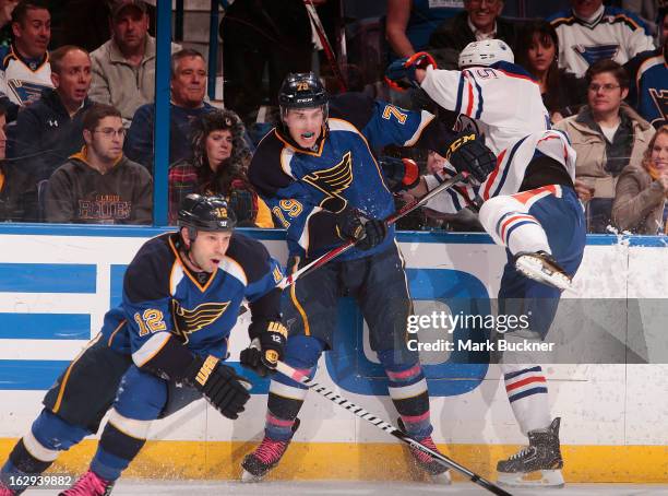 Ben Eager of the Edmonton Oilers collides with Adam Cracknell of the St. Louis Blues in an NHL game on March 1, 2013 at Scottrade Center in St....