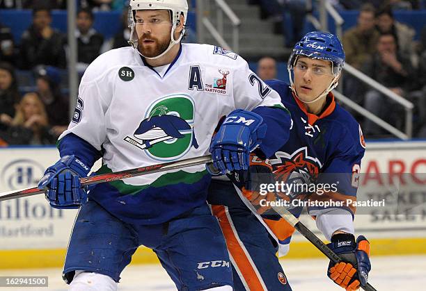 Brandon Segal of the Connecticut Whale skates against Nino Niederreiter of the Bridgeport Sound Tigers during an American Hockey League game on March...