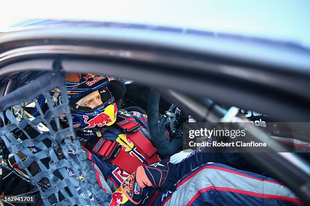 Casey Stoner driver of the Red Bull Pirtek Holden sits in his car prior to race two for round one of the V8 Supercars Dunlop Development Series at...