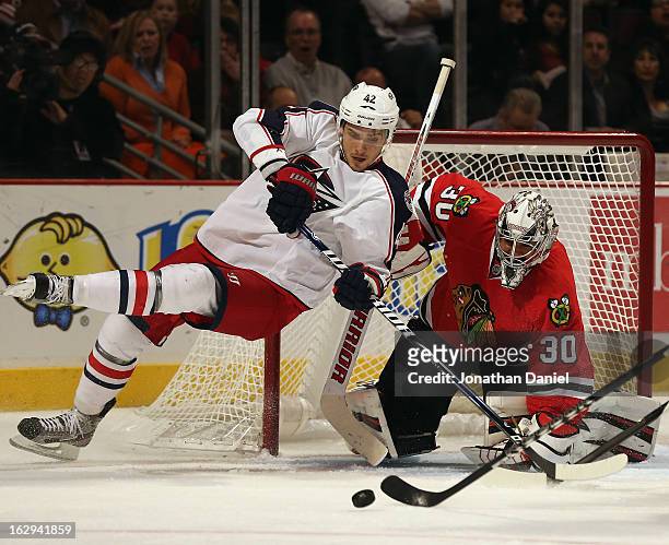 Artem Anisimov of the Columbus Blue Jackets looses his balance after Ray Emery of the Chicago Blackhawks rejected his shot at the United Center on...