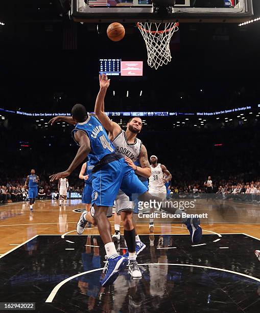 Darren Collison of the Dallas Mavericks blocks Deron Williams of the Brooklyn Nets in the second half at the Barclays Center on March 1, 2013 in New...