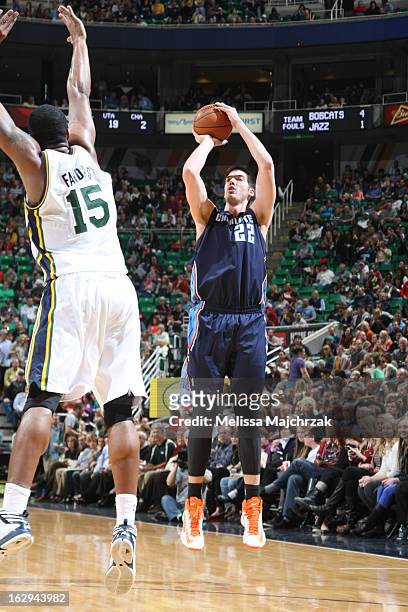 Byron Mullens of the Charlotte Bobcats shoots against Derrick Favors of the Utah Jazz at Energy Solutions Arena on March 1, 2013 in Salt Lake City,...