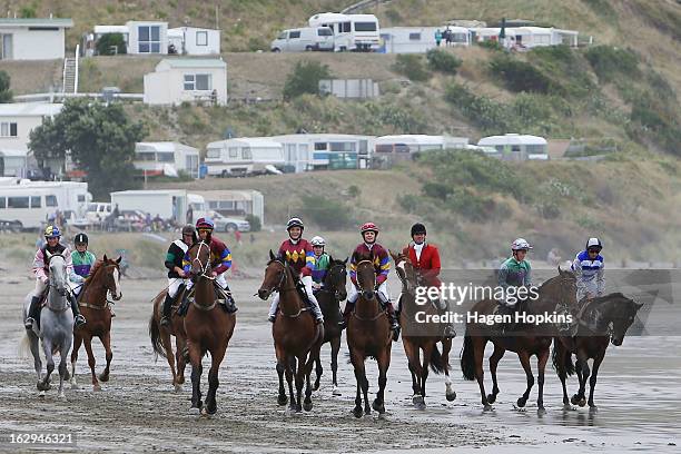 Horses arrive on the beach for the Tinui Highweight Handicap Open during the Castlepoint Beach Races at Castlepoint Beach on March 2, 2013 in...