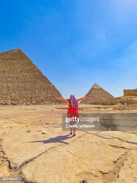 young woman enjoying the view of the pyramids of giza in cairo - giza stock pictures, royalty-free photos & images