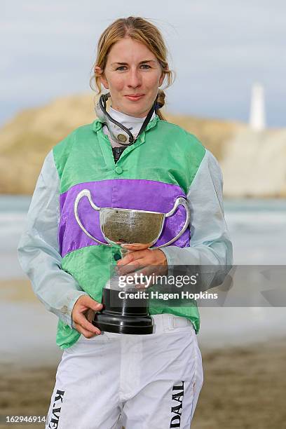 Kayla Veenendaal poses with the Castlepoint Cup after winning the Castlepoint Cup Open aboard The Rose during the Castlepoint Beach Races at...