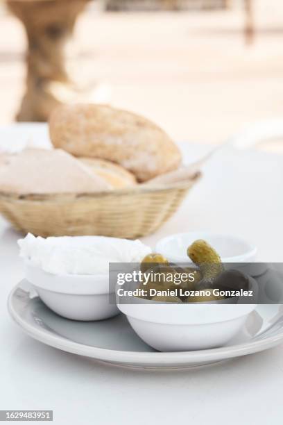 table with green olives and bread outdoors - aioli stock pictures, royalty-free photos & images