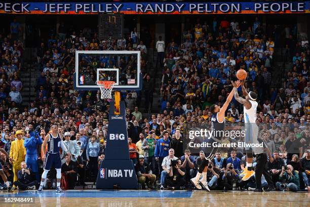 Ty Lawson of the Denver Nuggets makes the game-winning shot against Thabo Sefolosha of the Oklahoma City Thunder on March 1, 2013 at the Pepsi Center...