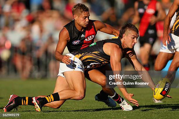 Dustin Martin of the Tigers and Leroy Jetta of the Bombers contest for the ball during the round two AFL NAB Cup match between the Essendon Bombers...