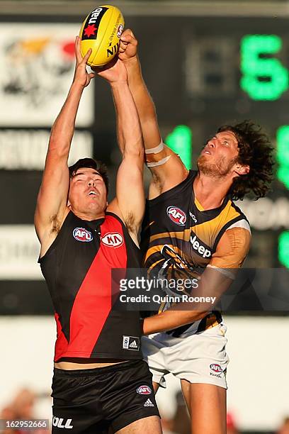 Michael Hibberd of the Bombers marks infront of Tyrone Vickery of the Tigers during the round two AFL NAB Cup match between the Essendon Bombers and...