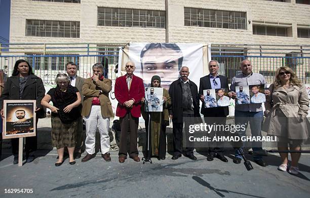 Layla Issawi holds a picture of her son Samer Issawi, a Palestinian held in Israeli jail and on hunger strike for more than 200 days, alongside her...