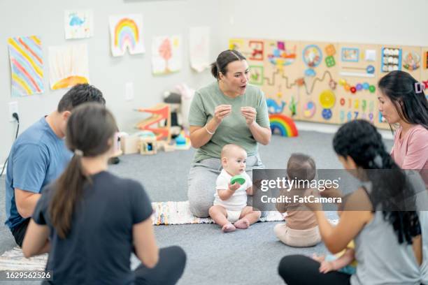baby sign language class - group of people using sign language stock pictures, royalty-free photos & images