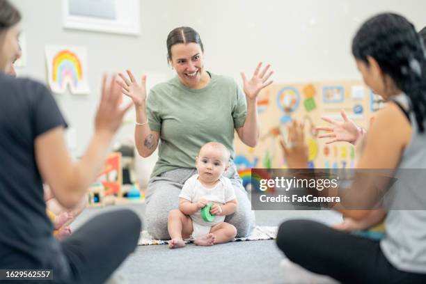baby sign language class - group of people using sign language stock pictures, royalty-free photos & images