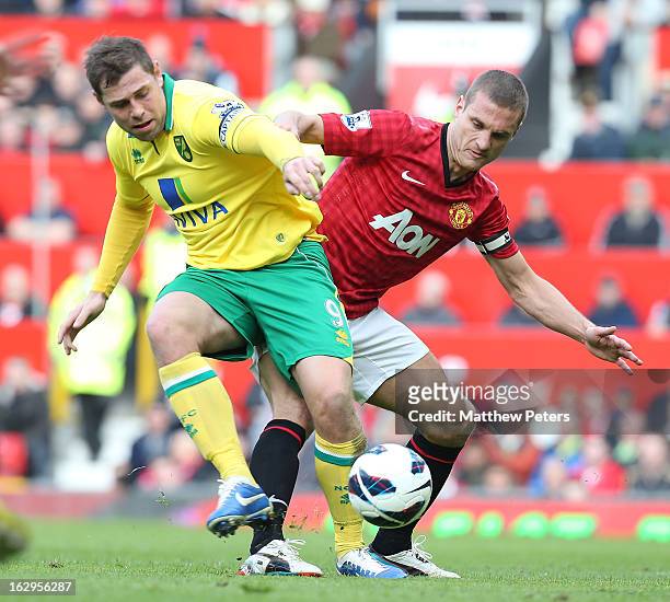 Nemanja Vidic of Manchester United in action with Grant Holt of Norwich City during the Barclays Premier League match between Manchester United and...