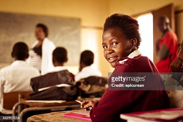 portrait of happy young south african girl in classroom - girl looking over shoulder stock pictures, royalty-free photos & images