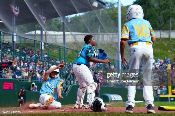 Brody Brooks of the West Region team from El Segundo, California slides safely into home during the Little League World Series Championship Game...