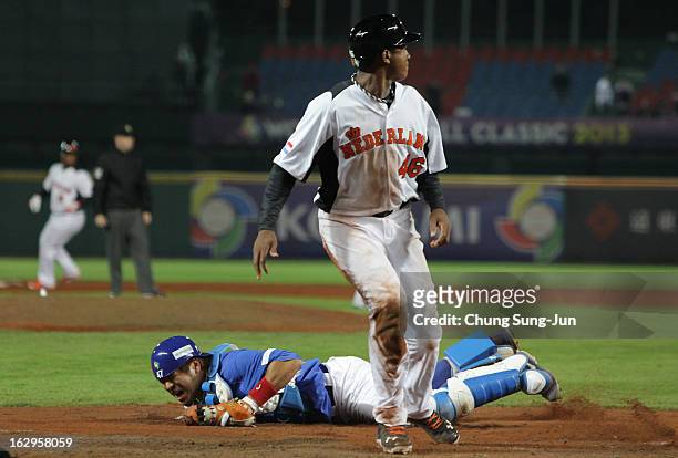 Kang Min-Ho of South Korea reacts after a collision with Jonathan Schoop of Netherlands bottom in the seventh inning during the World Baseball...
