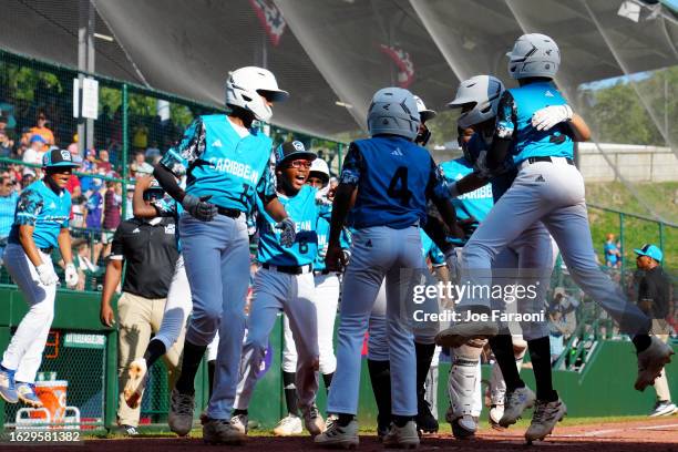 Members of the Caribbean Region team from Willemstad, Curacao celebrate at home plate during the Little League World Series Championship Game against...