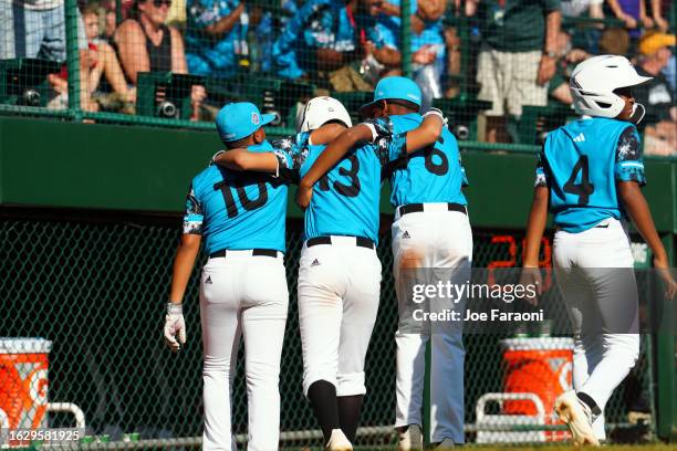 Jay-Dlynn Wiel, Nasir El-Ossaïs and D'Shawn Winklaar of the Caribbean Region team from Willemstad, Curacao walk back to the dugout during the Little...