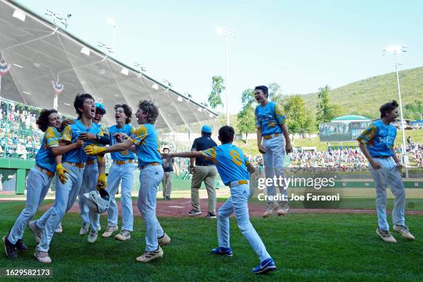 Louis Lappe of the West Region team from El Segundo, California celebrates with teammates after hitting a walk off home run to beat the Caribbean...